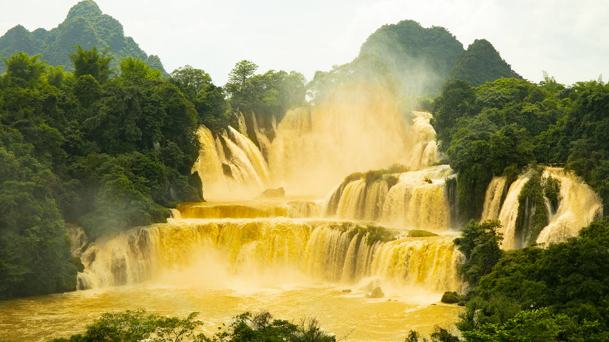 Asia's largest cross-border waterfall turns golden